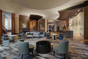 Experience the Renaissance hotel's sleek, modern design, marked by a prominent glass facade and welcoming entrance.