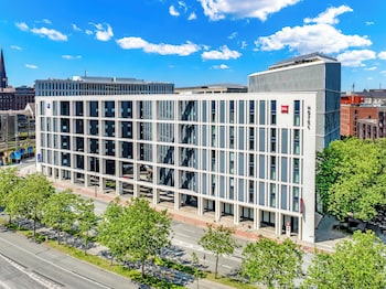 A modern building with a flat facade, large windows, and a central entrance.