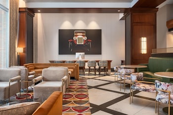Un lobby moderno con chimenea, asientos cómodos y ventanas amplias que ofrecen vistas al exterior.