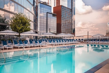A high-rise building with a panoramic city view from a balcony.