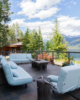 Relax in a serene forest setting with a hot tub on the deck.