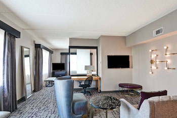 A modern lobby with a stone accent wall, seating area, and large windows.