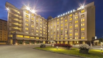A multi-story hotel with a modern design, featuring a prominent 'Hilton' sign on the facade.