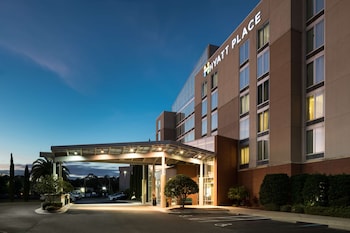 A multi-story hotel with a modern design, featuring a prominent "HYATT PLACE" sign.