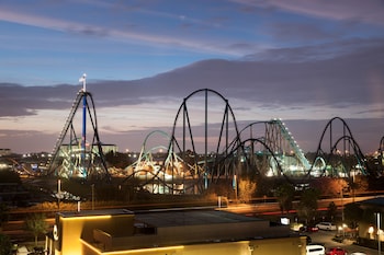 A roller coaster at dusk with a clear sky.