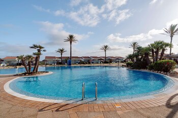 Outdoor pool, open 8:00 AM to 8:00 PM, pool umbrellas, sun loungers