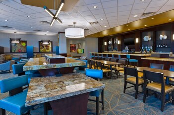 A spacious lobby with a central seating area, multiple floors, and a modern design.