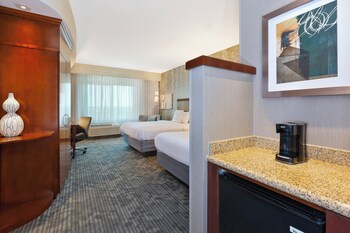 A spacious lobby with a central seating area, multiple floors, and a modern design.