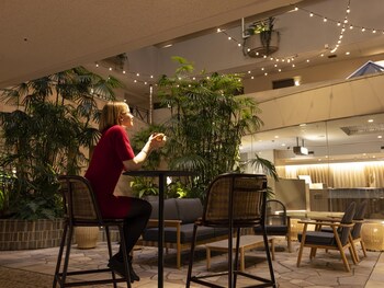 A lobby with a central planter, seating area, and a curved reception desk.