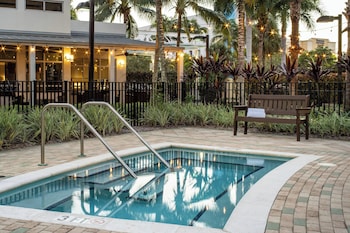 A modern house with a patio area featuring outdoor furniture and a fire pit.