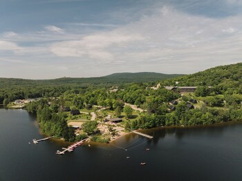 Enjoy casual dining on the lakeside deck with comfortable seating and a shaded area.