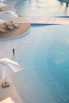 On the beach, white sand, sun loungers, beach umbrellas