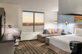 Relax in our spacious seating area, enjoy meals at the communal dining table, and check in at our modern reception desk.
