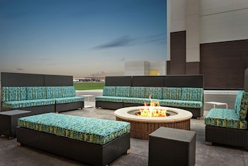 Relax by the fire pit in this inviting outdoor seating area, surrounded by comfortable sofas and chairs.