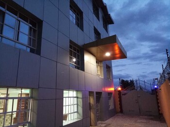 Stylish building with a flat facade and covered entrance area.