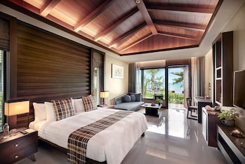 A resort with a pool, beach, and mountain views.