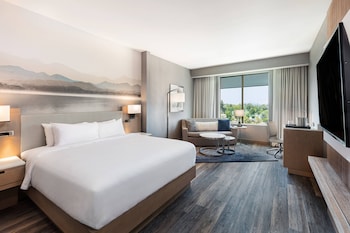A spacious lobby with modern furniture, a large seating area, and large windows offering views of the outside.