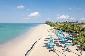 On the beach, white sand, sun-loungers, beach umbrellas