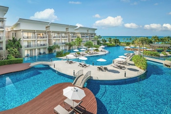 On the beach, white sand, sun loungers, beach umbrellas