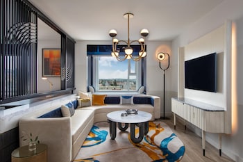 Relax by the pool surrounded by lush greenery and comfortable seating areas.