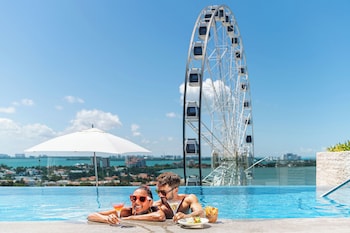 A swimming pool with a Ferris wheel in the background.