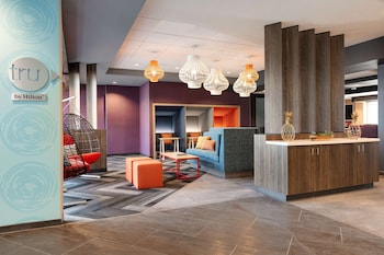 Relax in a spacious room with a large bed, desk, and city view.