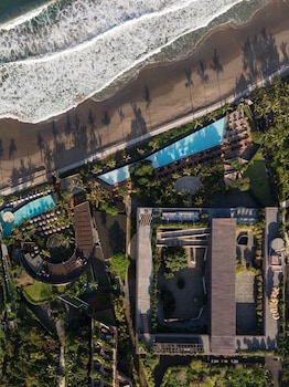 On the beach, white sand, beach cabanas, sun-loungers