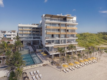 On the beach, white sand, beach cabanas, sun loungers