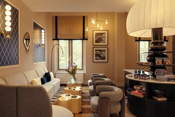 A buffet with various food items, a coffee machine, and hanging decorative lights.