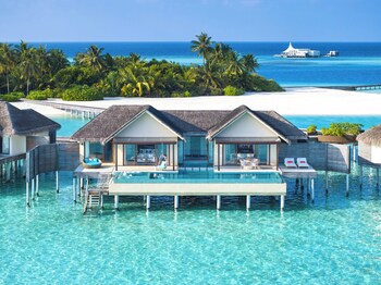 Relax by the turquoise ocean with a view of the sandy beach from the comfort of a modern resort.