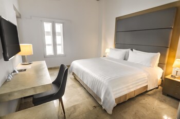 Relax on the spacious terrace with comfortable seating and dining areas, overlooking a serene river and cityscape.