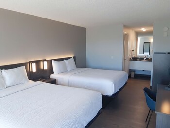 Welcome to our reception area, featuring a digital screen, comfortable seating, and a view of the outdoors.