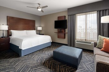 Relax in our stylish lobby with a comfortable seating area, round tables, and a bar.