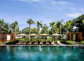 Relax by the pool with comfortable lounge chairs and umbrellas.