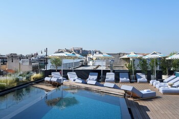 Outdoor pool, open 10:00 AM to 7:00 PM, pool umbrellas