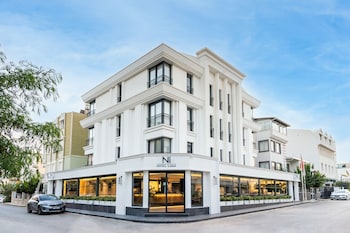 A modern restaurant with a central counter, seating area, and large windows.
