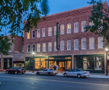 A restaurant with brick walls, framed awards, and a bar area.