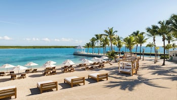 A resort with a pool, beach, and ocean views.