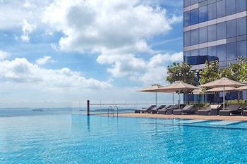 Outdoor pool, open 6:00 AM to 10:00 PM, pool umbrellas, sun loungers
