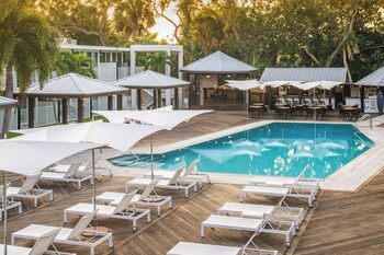 Enjoy al fresco dining on the deck with comfortable seating and pool views.