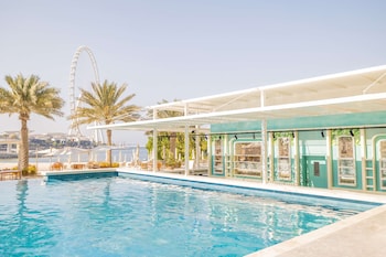 2 outdoor pools, open 9 AM to 9 PM, pool umbrellas, pool loungers