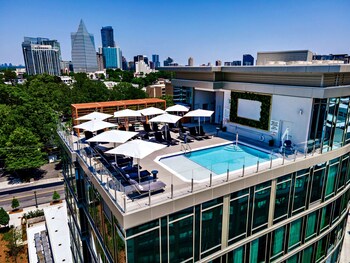 Enjoy breathtaking city views from this rooftop terrace, featuring comfortable lounge seating and a refreshing pool.