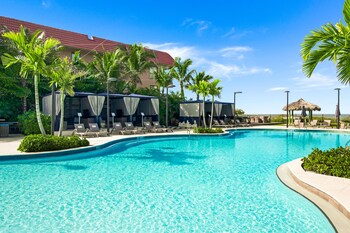 On the beach, white sand, sun loungers, beach umbrellas