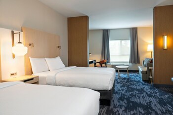 Experience the sleek, modern design of this hotel, featuring a combination of brick and glass facades and beautifully maintained grounds.