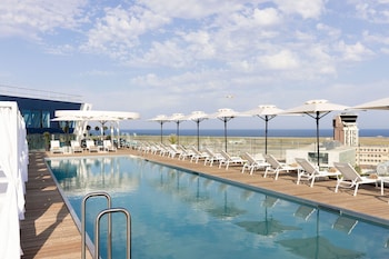 Seasonal outdoor pool, open 10:00 AM to 6:00 PM, pool umbrellas