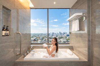 A rooftop pool with a city skyline in the background.