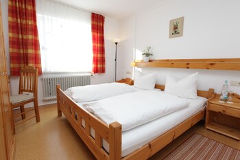 A hotel named "Hotel Land der Sonne" with outdoor seating and a garden.