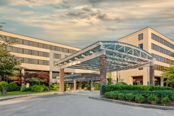 A spacious atrium with a central garden, multiple floors, and a distinctive white gazebo.