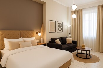 Relax in a stylish room with a large bed, comfortable armchair, and desk, offering a city view.