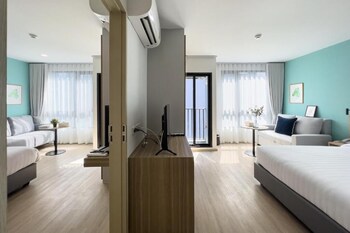 A spa area with a hot tub, bamboo wall, and a tiled wall.